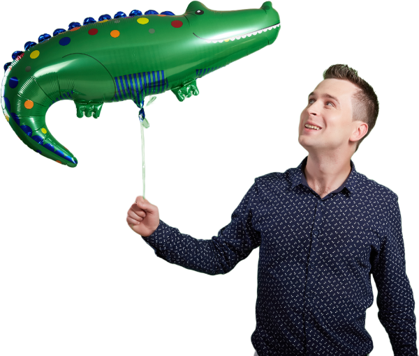 young man holding a crocodile foil balloon